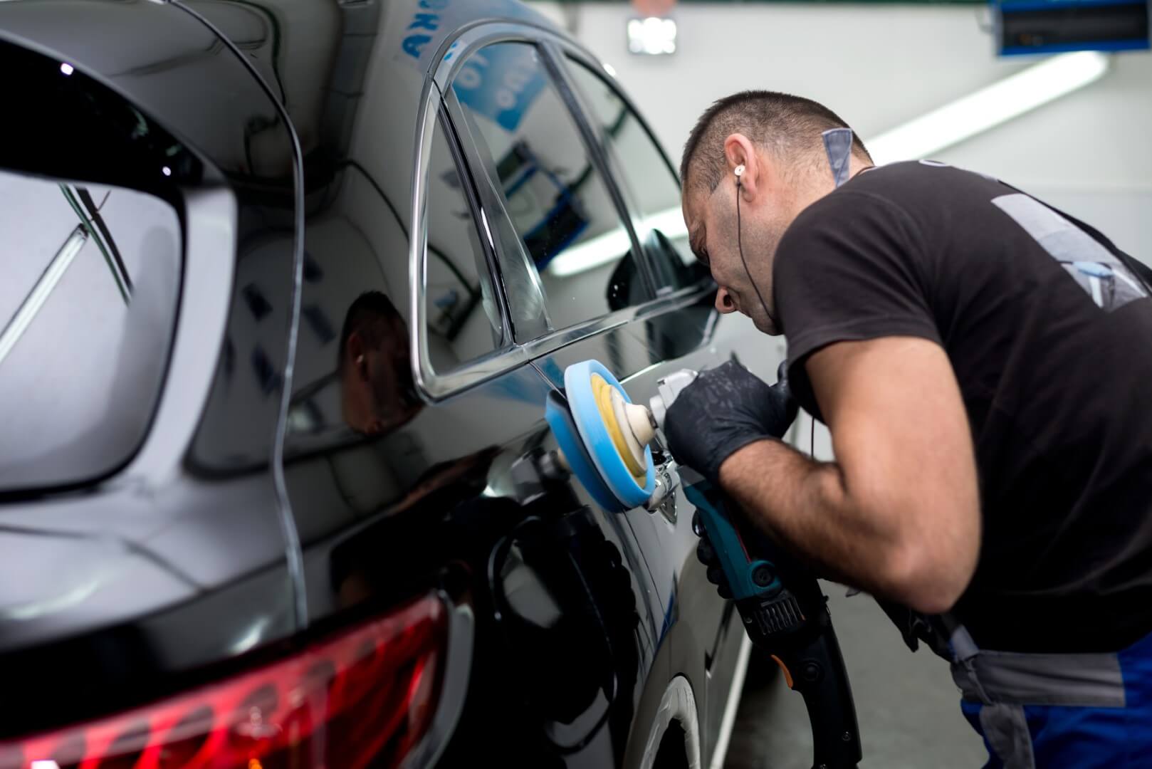 Car detailing expert from Oakville waxing a car.